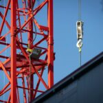 a crane that is hanging from the side of a building