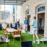 men playing cornhole boards